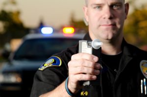 police officer with breathalyzer - Missouri DUI