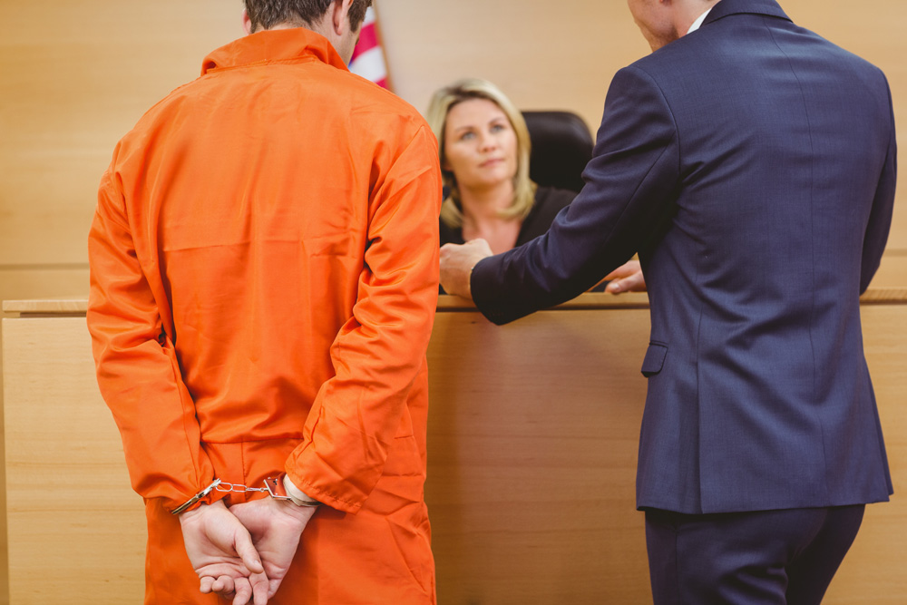man in handcuffs before a judge