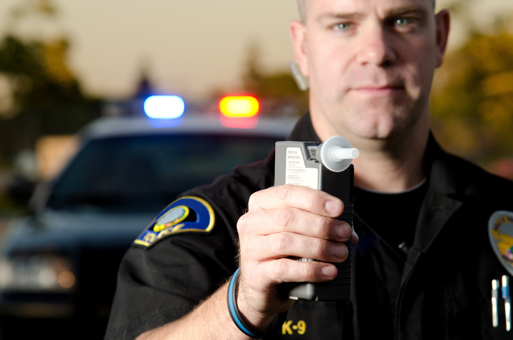 police officer with breathalyzer - Missouri DUI