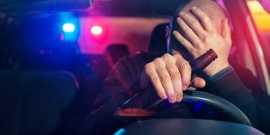 man drinking a beer at the wheel - Springfield DWI lawyers