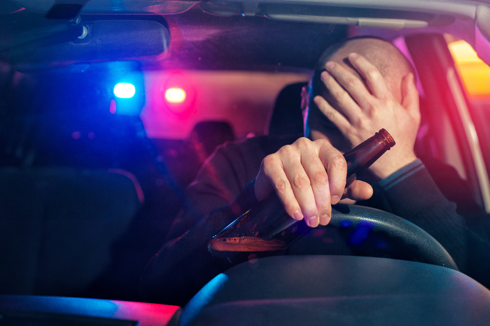 man drinking a beer at the wheel - Springfield DWI lawyers