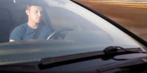 man sitting in the driver's seat of a car