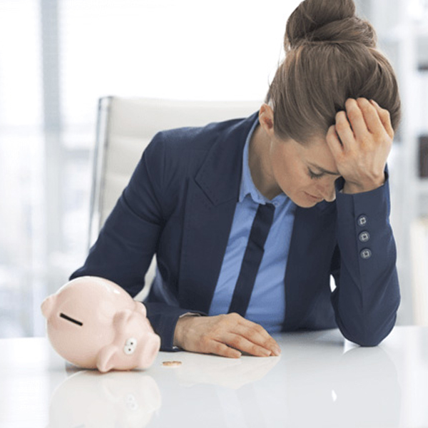 woman next to an empty piggy bank