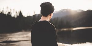 Man with beanie staring at mountains