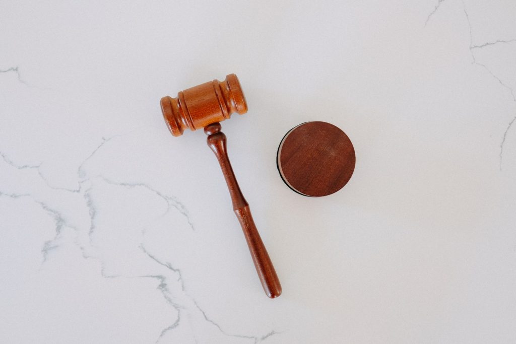 wooden gavel on white marble surface