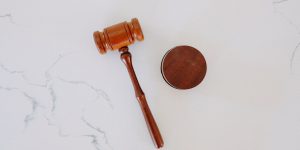 wooden gavel on white marble surface